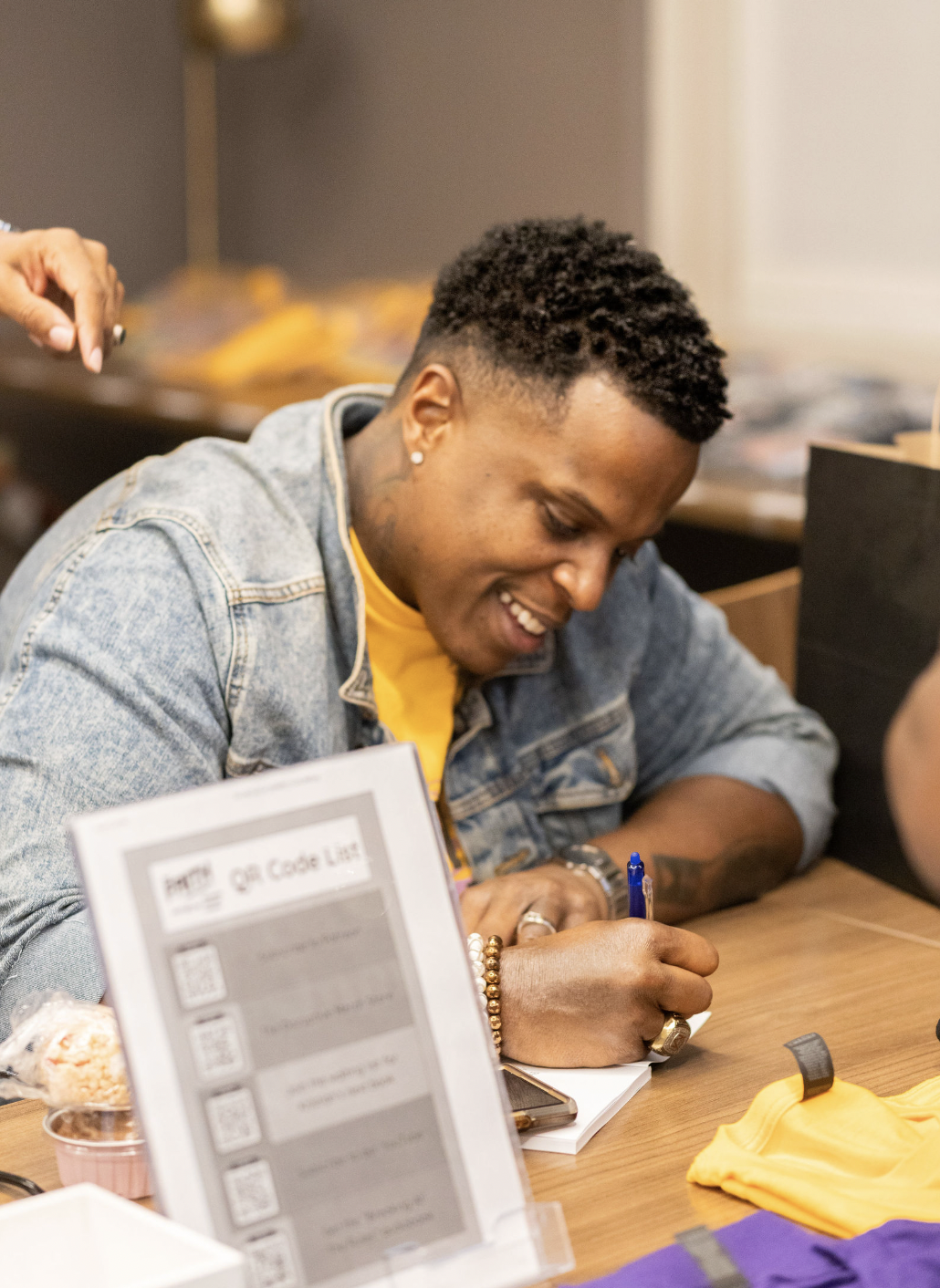 Kristian A. Smith signing at a table